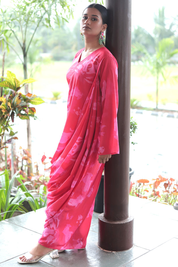 Woman wearing Mush Clothing pink gown with a floral pattern in drape style