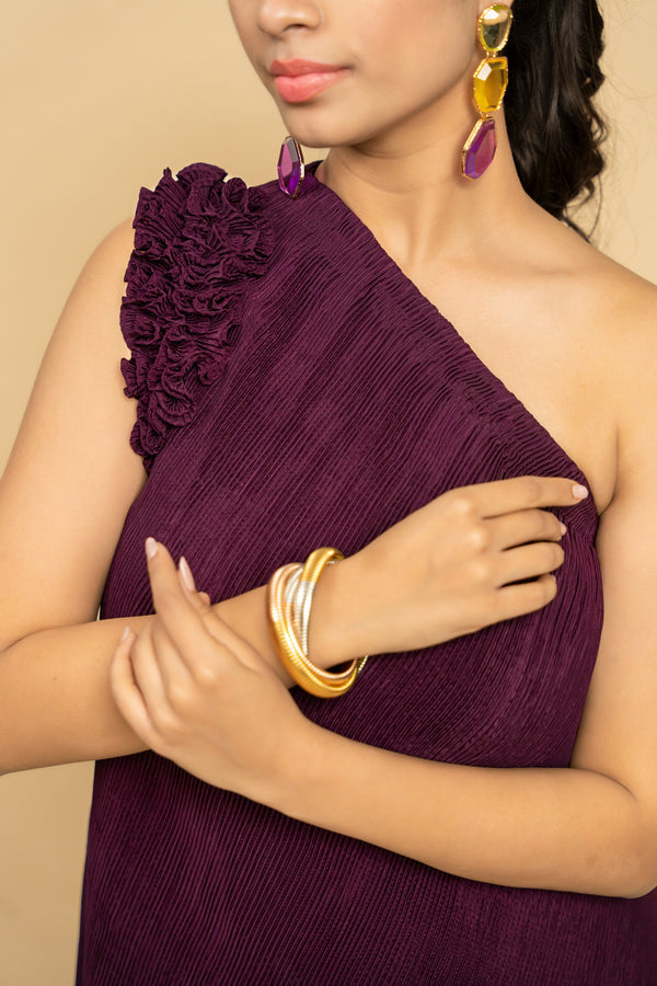Woman wearing a purple one-shoulder dress 