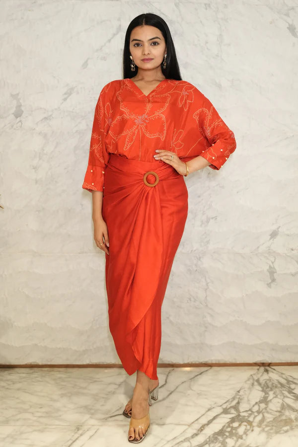 Woman wearing a Red Bandhani printed Loose top With Wrap Round Skirt With Buckle Co-Ord Set