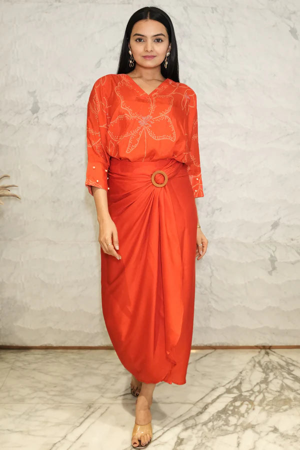 Woman wearing a Red Bandhani printed Loose top With Wrap Round Skirt With Buckle Co-Ord Set