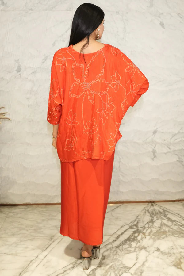 Woman wearing a Red Bandhani printed Loose top With Wrap Round Skirt With Buckle Co-Ord Set