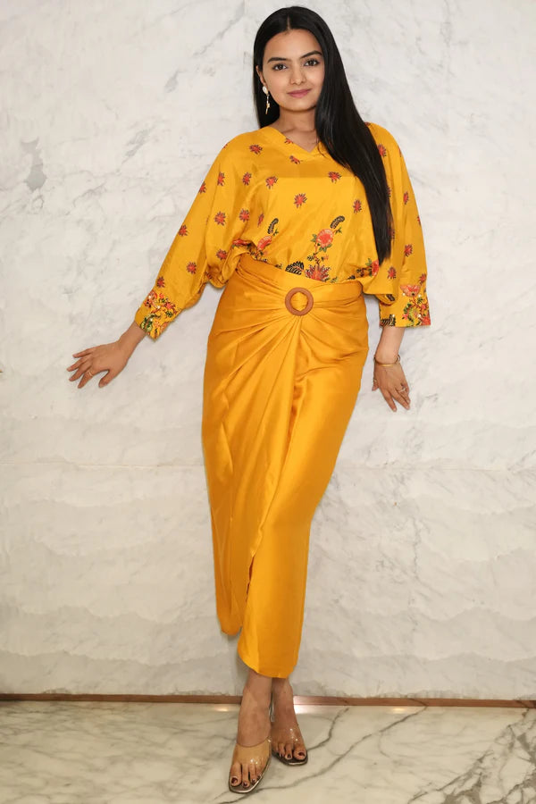 Woman wearing a Mustard yellow floral  printed Loose top With Wrap Round Skirt With Buckle Co-Ord Set